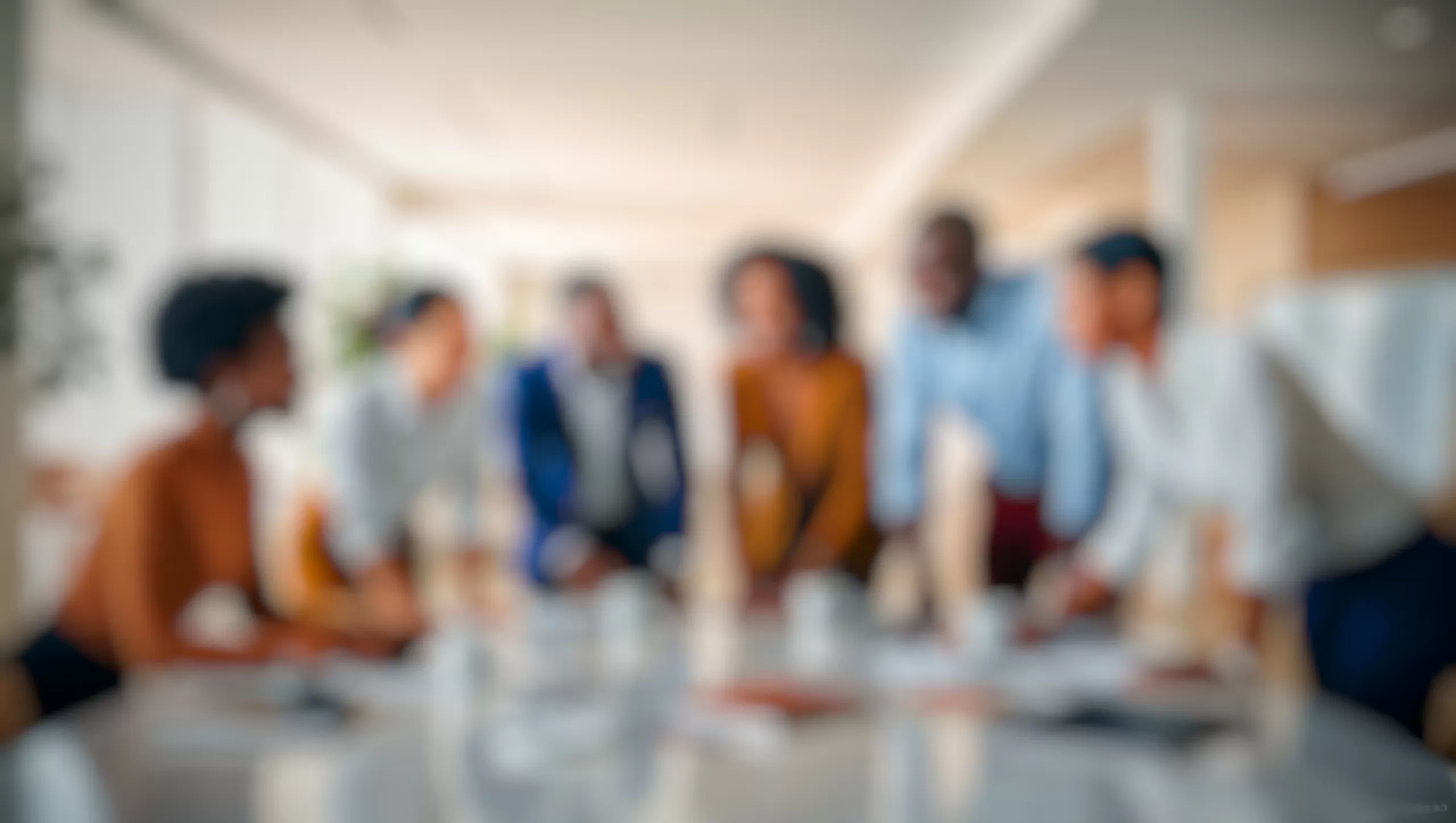 Defocused image of a diverse leadership team collaborating, representing vision, alignment, and execution in leadership development.