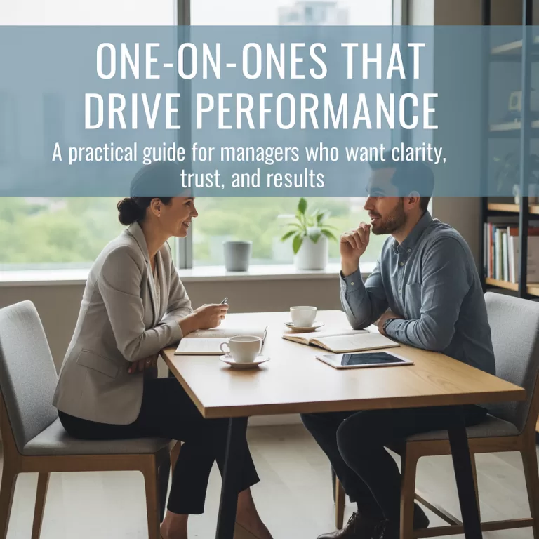 Manager and employee having a one-on-one meeting at a modern office table, discussing goals and performance; featured image for blog on effective one-on-one conversations.