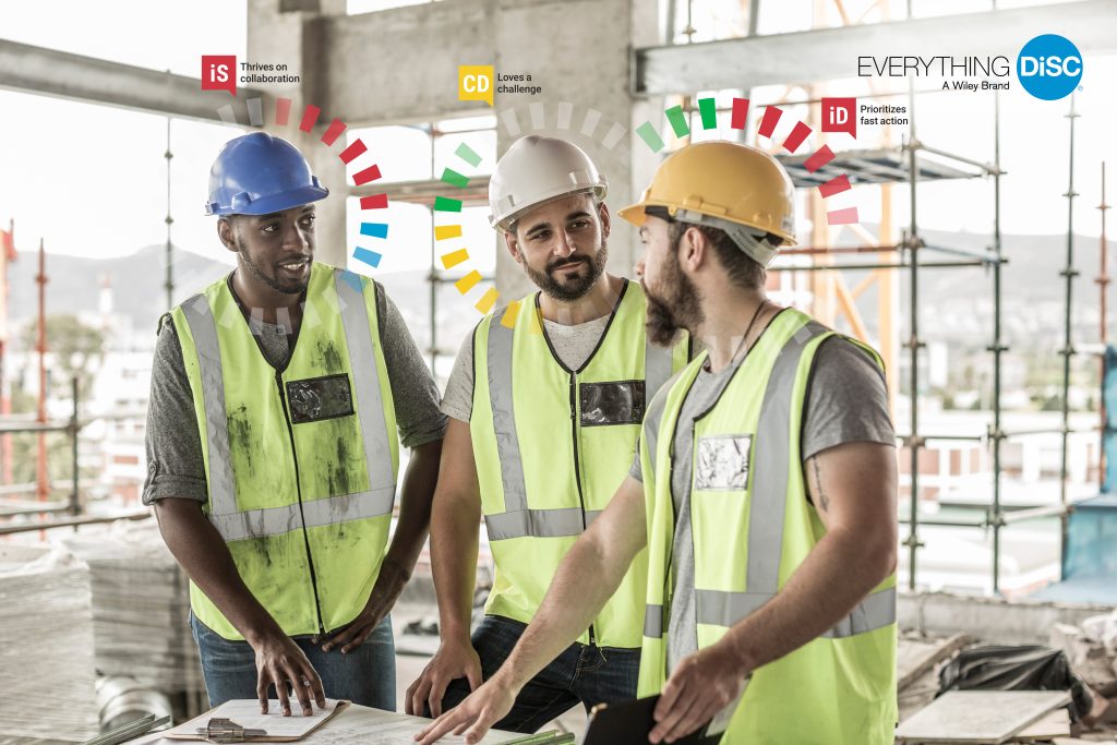 "Three construction workers wearing safety vests and hard hats, each identified with a DiSC® style overlay, demonstrating team dynamics and communication preferences."